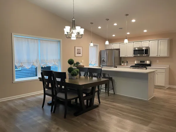 a large kitchen with a table and chairs