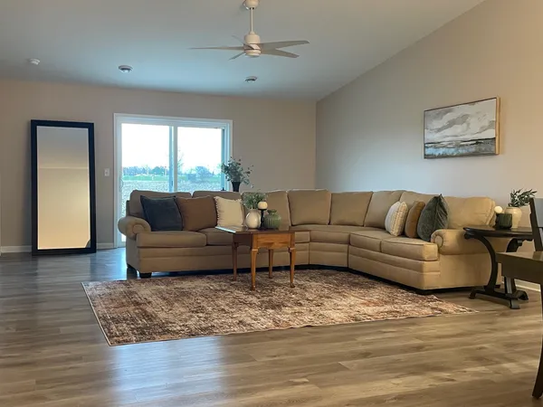 a living room with furniture and a wooden floor
