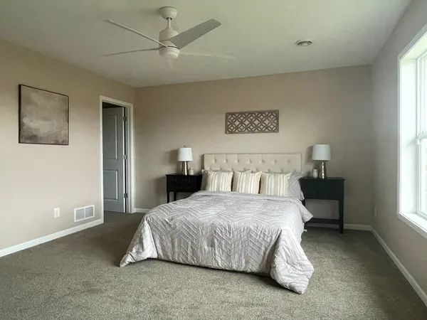 a bedroom with a bed and a night stand