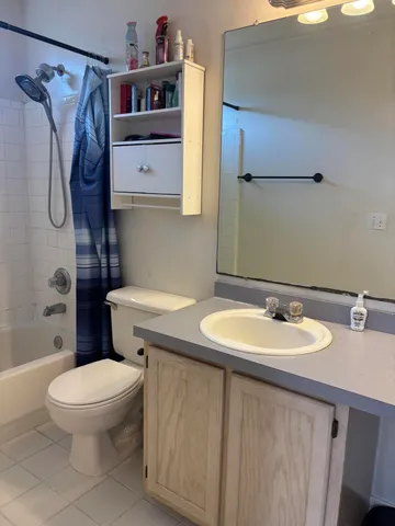 a white toilet sitting next to a bathroom sink