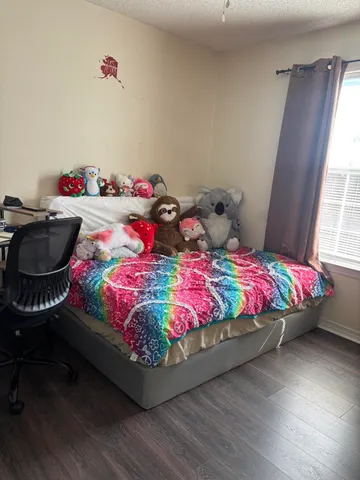 a bedroom with a bed and window