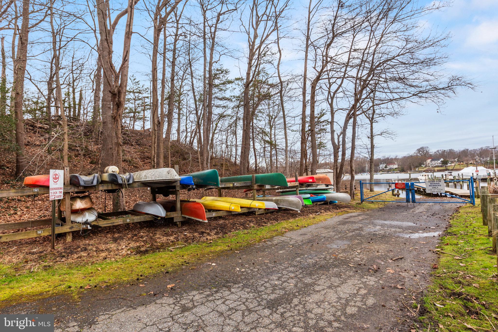 218 Lees Lane Edgewater, MD 21037 - Photo 41 of 41 Colorful kayaks by the serene shore.