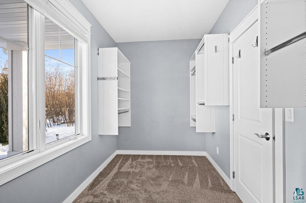 3879 Okerstrom Road Hermantown, MN 55811 - Photo 16 of 32 Walk in closet featuring dark colored carpet