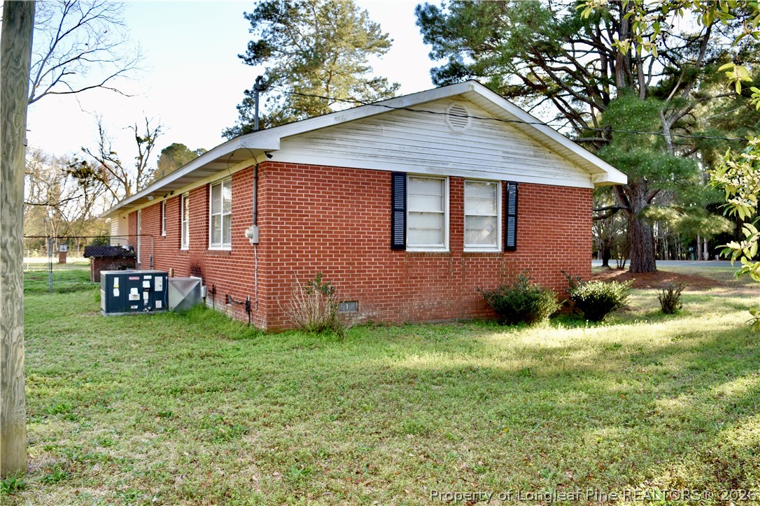 5309 Tobacco Road Orrum, NC 28369 - Photo 35 of 44 a backyard of a house with yard and trampoline