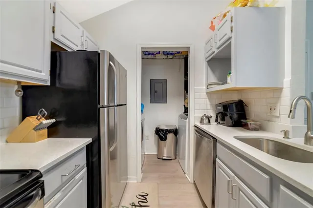 a kitchen with a sink and refrigerator