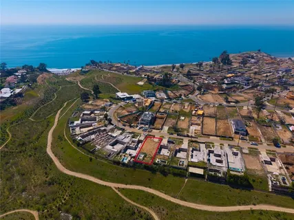 an aerial view of a house with a ocean view