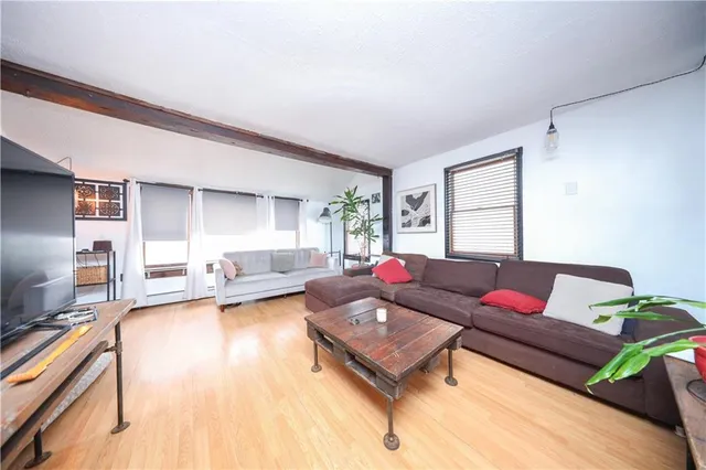 a kitchen with stainless steel appliances kitchen island granite countertop a table chairs in it and wooden floors