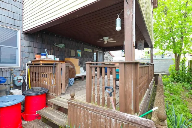a view of a patio with couches chairs and wooden floor