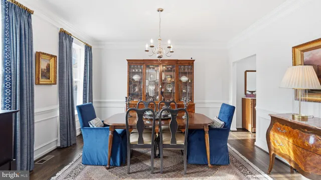 a view of a dining room with furniture and chandelier