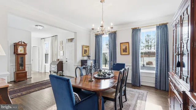 a view of a a dining room with furniture window and wooden floor