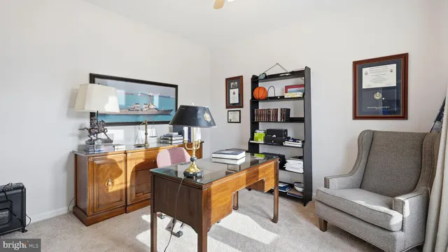 a living room with furniture and painting on the wall