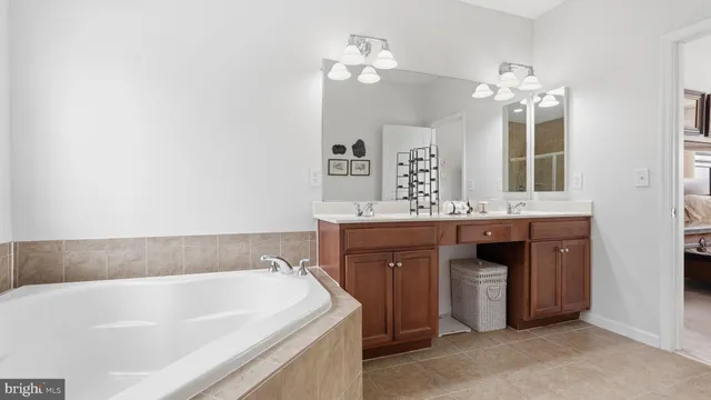 a bathroom with a tub sink and a mirror