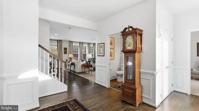 a hall way with wooden floor and windows