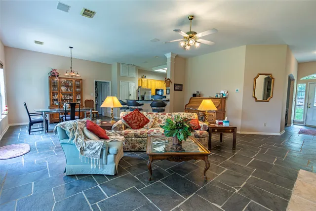 a living room with fireplace furniture and a chandelier