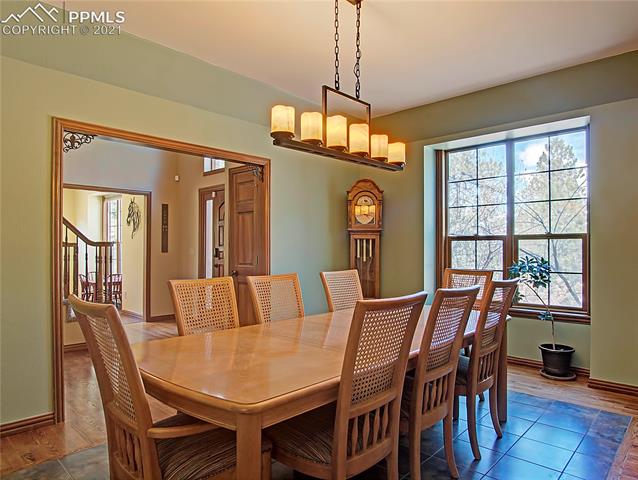 735 Winding Hills Road Monument, CO 80132 - Photo 5 of 42 Dining room has hardwood and tile flooring