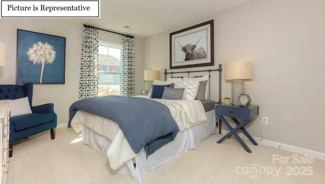 a bedroom with a bed and a painting on the wall