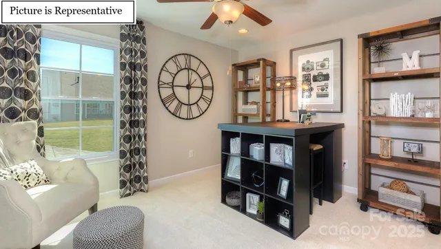 a living room with furniture and a book shelf
