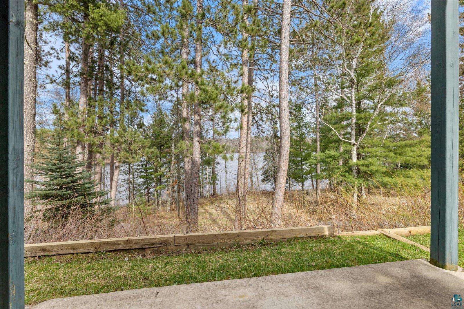 6266 Giants Ridge Road Biwabik, MN 55705 - Photo 34 of 37 Concrete patio opening onto a grassy area with a timber retaining wall