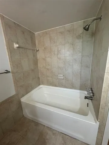 a bathroom with a shower and a bath tub