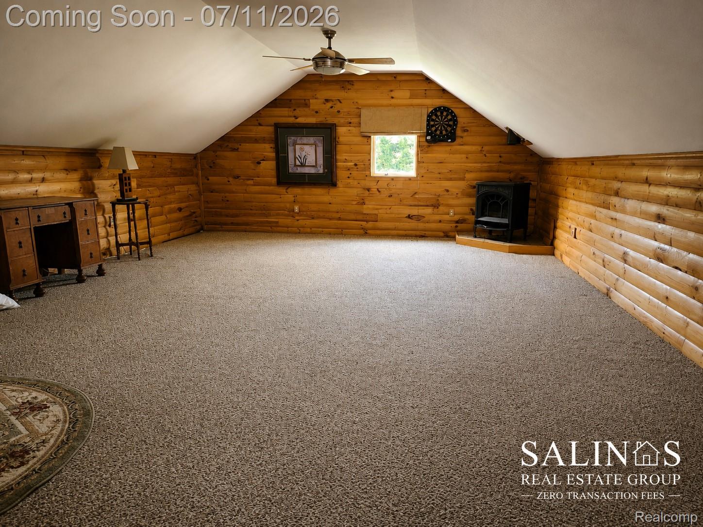 2120 Montague Road Davison, MI 48423 - Photo 33 of 37 Spacious room featuring log-style walls, sloped ceilings, and broadloom carpeting
