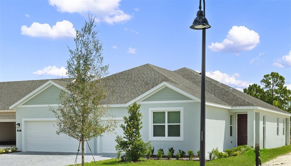 737 Farfields Street DeLand, FL 32724 - Photo 1 of 1 a front view of a house with garden