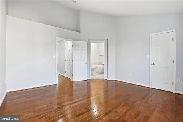 a view of an empty room and wooden floor
