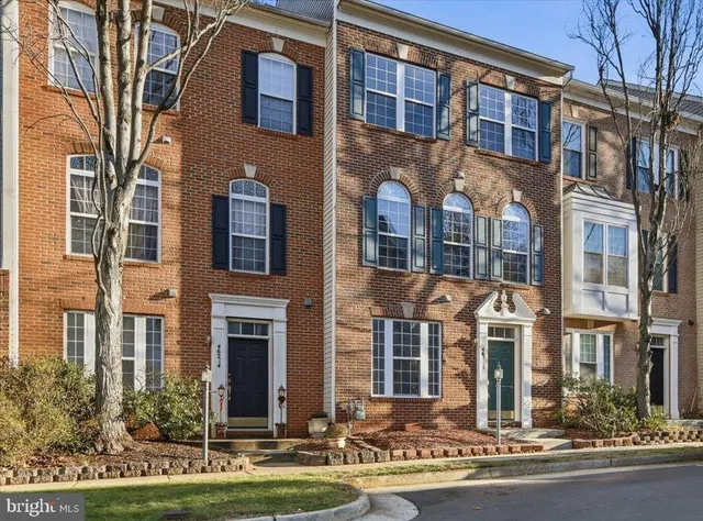 view of a brick building next to a yard