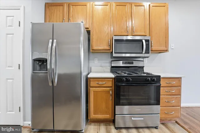 a kitchen with a refrigerator and a stove