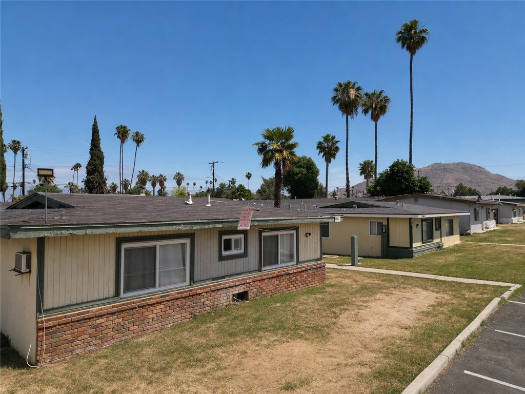 a view of a house with a backyard and a yard