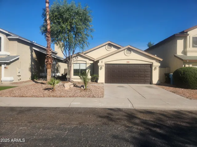 a view of a house with a yard and garage