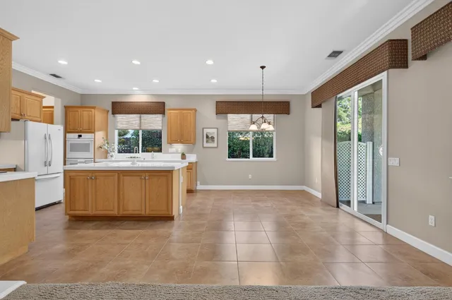 a view of an empty room and a ceiling fan
