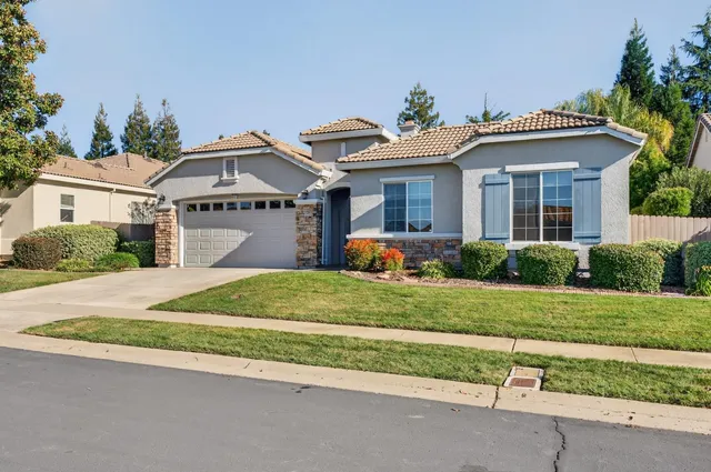 a view of an empty room with a window and potted plants