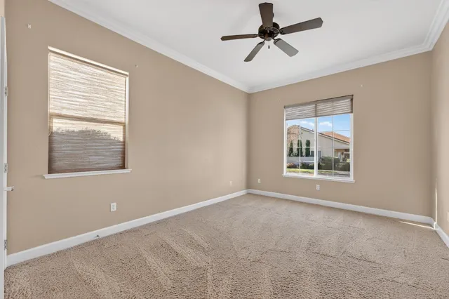 an aerial view of a house with a yard and lake view