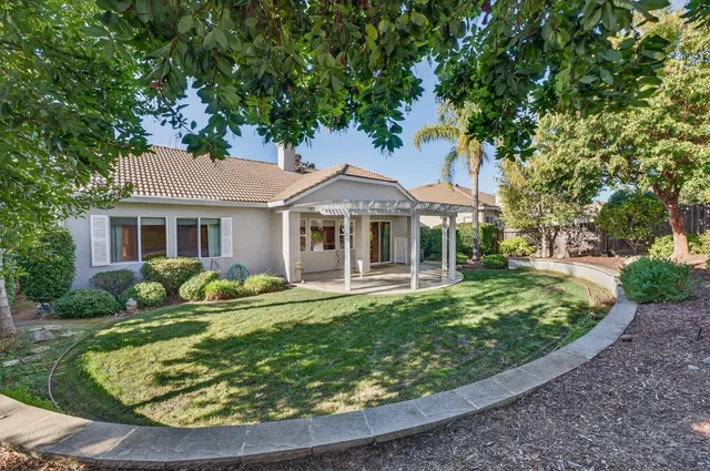a living room with furniture a fireplace and a chandelier