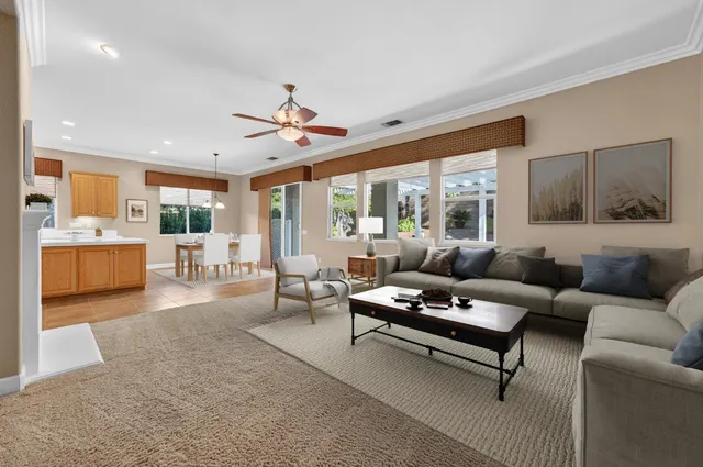 a kitchen with stainless steel appliances granite countertop a stove top oven a sink a refrigerator and a cabinets