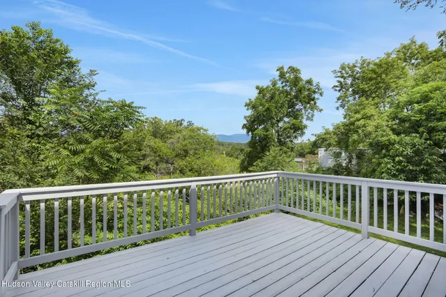 a view of balcony with wooden floor and fence