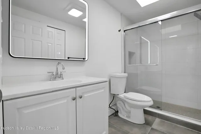 a bathroom with a sink a toilet and vanity