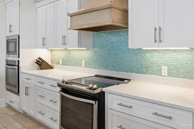 a kitchen with stainless steel appliances a sink stove and refrigerator