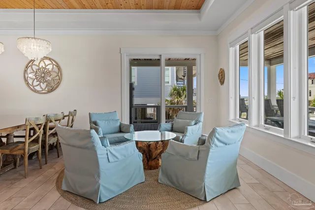 a bedroom with a bed couch and windows