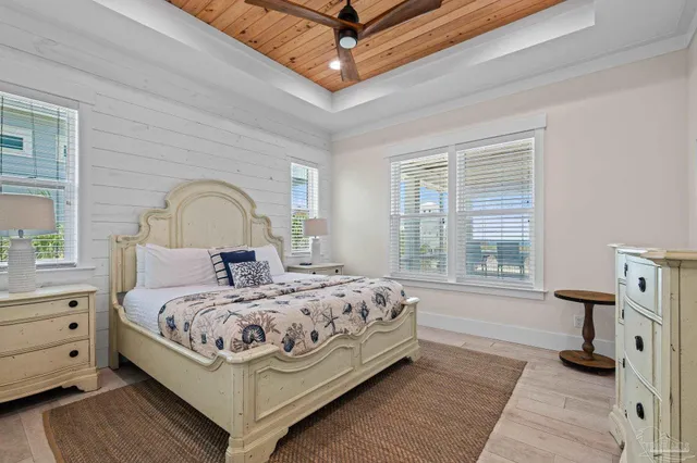 a bedroom with a bed mirror and a window