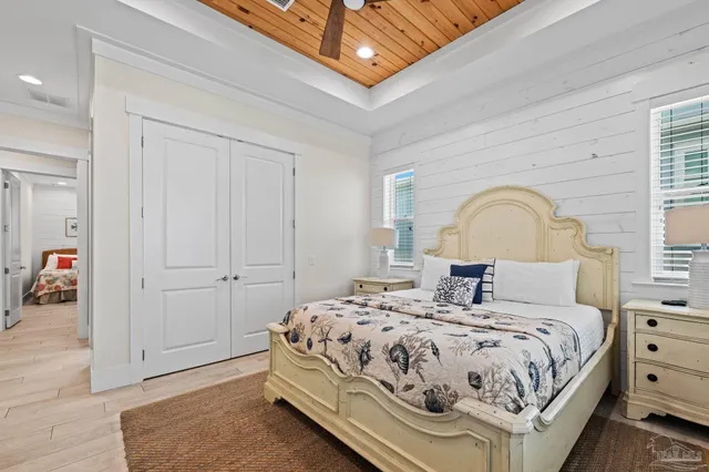 a bedroom with a bed table and chair