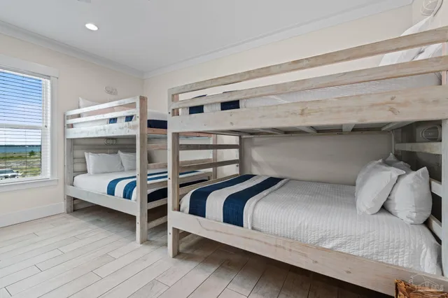 a bedroom with two beds and a chandelier