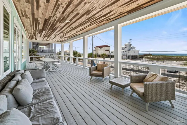 a view of a chairs and table in the balcony