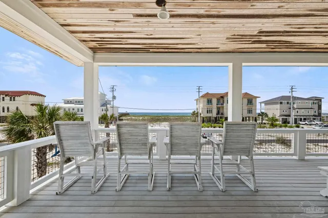 a view of a patio with table and chairs wooden floor and barbeque oven