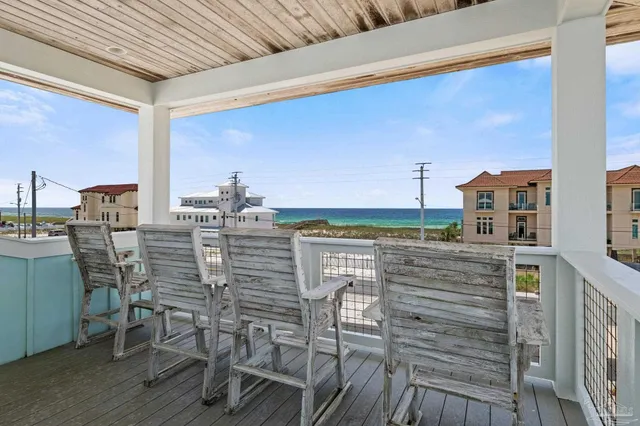a balcony with furniture and large windows