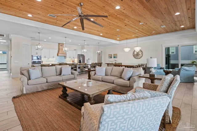 a kitchen with kitchen island a refrigerator a stove a dining table and chairs