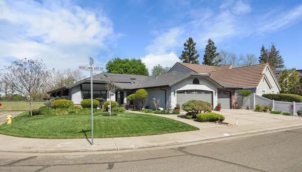 a front view of a house with a garden