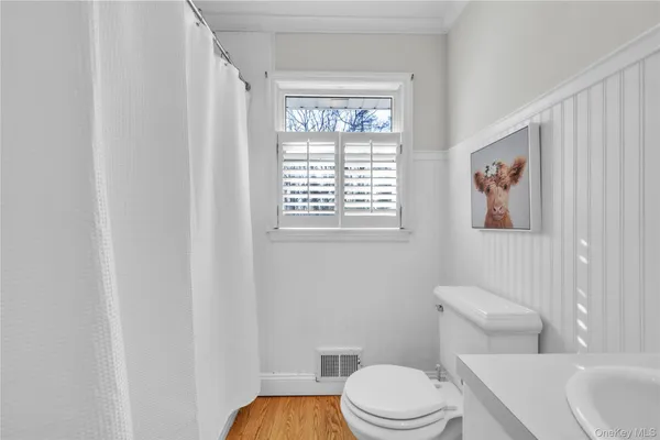 a white toilet sitting next to a bathroom sink and tub