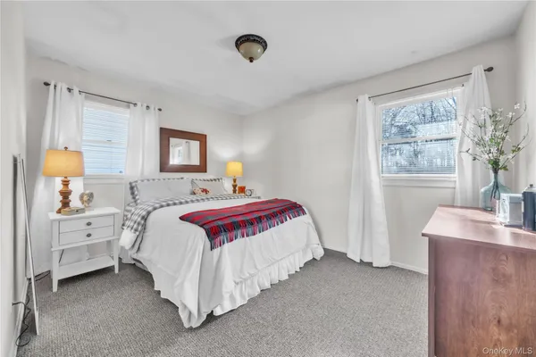 a spacious bedroom with a bed and window