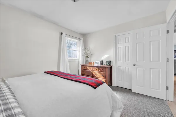 a bed room with a bed and a window